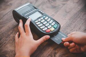 Paying by credit card , buying and selling products using a credit card swipe machine photo