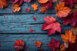 AI generated Autumn red leaves on a blue wooden background photo