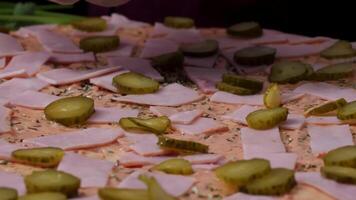 Hands preparing a pizza. Frame. Cook in the kitchen putting the ingredients on the pizza. Pizza concept. Production and delivery of food. Closeup hand of chef baker in white uniform making pizza at video