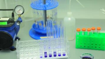 Many test tubes in a test in a research laboratory of a university. symbolic photo for learning and researching. Glass in a chemical laboratory filled with colored liquid during the reaction. video