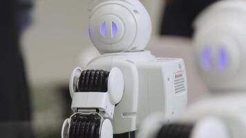 SHANGHAI - JUNE 28 2018. A small robot with human face and body - humanoid. Closeup of an cute autonomous service robot. Close-up of robot head video