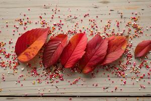 AI generated Autumn red leaves on a blue wooden background photo