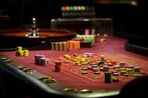 close-up chips and roulette at the casino on the red table photo