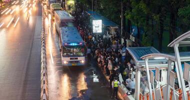 BANGKOK, THAILAND - JUNE 9. Busy bus station in the Mo Chit area of Bangkok after the Chatuchak market has closed many people come to this stop to wait for a bus. TIMELAPSE video