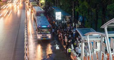 BANGKOK, THAILAND - JUNE 9. Busy bus station in the Mo Chit area of Bangkok after the Chatuchak market has closed many people come to this stop to wait for a bus. TIMELAPSE video