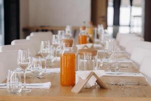 Empty dishes and cutlery on the table in the restaurant before dinner photo