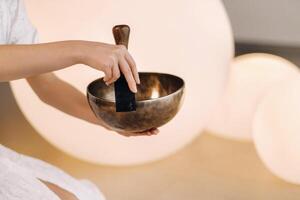 Tibetan singing bowl in your hands - Translation of mantras transform your impure body, speech and mind into a pure exalted body, speech and mind of a Buddha photo