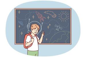 Joyful boy stands near blackboard depicting universe with spaceships and planets. Vector image