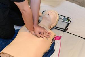 CPR First Aid Training with CPR dummy in the class photo