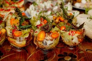 portioned vegetable salad in the foreground of the table with assorted food photo