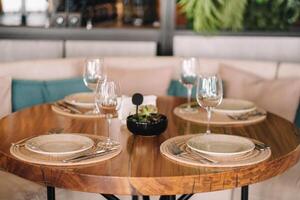 Empty dishes and cutlery on the table in the restaurant before dinner photo