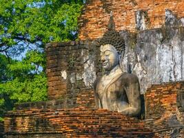 Buddha at Wat Mahathat temple in Sukhothai historical park, UNESCO World Heritage Site, Thailand photo