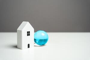 House and blue globe. Internet access concept. Digitally connected home, offering a global gateway to information and communication. photo