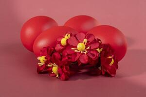 Colorful eggs, symbolizing Easter, on a colorful background and flowers photo