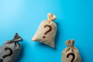 Bags with question marks. Inquiry, surprises or hidden secrets. Business and finance. Challenges and cases. photo