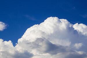 Huge fluffy cumulus cloud on blue sky. Formation before thunderstorm. Copy space photo