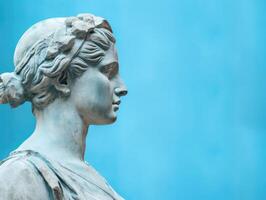 AI generated Antique goddess Statue for Collage and surreal images in Y2K style. Ancient Greek female Sculpture With cracked clay in profile. Woman with blue pastel background with copy space photo