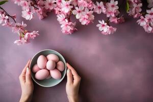 AI generated Top view of hands and Easter Eggs in bowl. Flat lay spring floral arrangement with copy space. Pastel background for banner with empty space for text and purple April Flowers photo