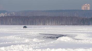 Winter tyres of a cars on a snowy road. Tires on the road are covered with snow on a winter day. Car drives on a snowy road video