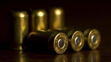 Bullets closeup on black backgrounds. Rubber bullets macro with limited dof on a black background, 9mm full metal jacket. bullet macro with limited dof on a black background video