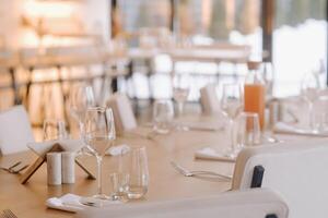 Empty dishes and cutlery on the table in the restaurant before dinner photo