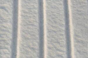 invierno antecedentes. el textura de nieve con rayas. puro blanco nieve foto