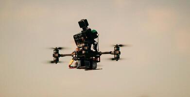 one flying small drone in the dark sky in retro style close with copy space photo