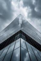 AI generated image shows tall skyscraper reaching into an overcast sky. The building is constructed with reflective glass panels that mirror the surrounding buildings and sky Ai Generated photo