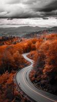 ai generado foto montaña la carretera puesta de sol rodeado por alto rocoso montañas y verdor debajo un nublado cielo ai generado