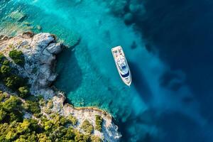 AI generated Aerial drone view top down ultra wide photo of luxury yacht anchored in tropical exotic island bay with crystal clear turquoise Ai Generated