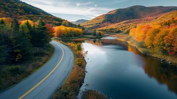 AI generated Photo of road beside calm river, nestled between lush green and autumnal colored mountains Ai Generated