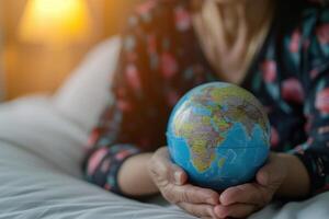 AI generated Elderly Asian patient with globe symbolizes health in hospital. photo