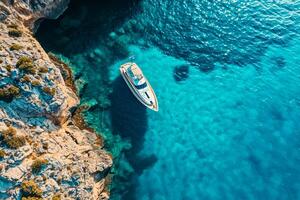 AI generated Aerial drone view top down ultra wide photo of luxury yacht anchored in tropical exotic island bay with crystal clear turquoise Ai Generated