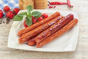 Roasted sausages in the plate photo