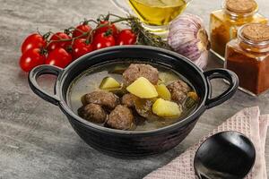 Soup with meatball and potato photo