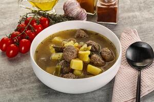 Soup with meatball and potato photo