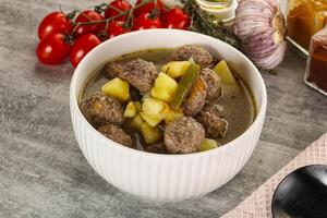 Soup with meatball and potato photo