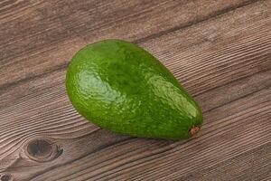 Ripe green avocado over background photo