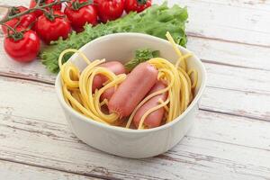 Mini sausages with pasta spaghetti photo