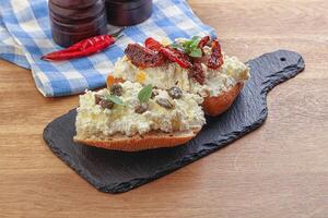 bruschetta with soft cheese capers and tomato photo