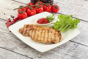 Grilled pork steak with ketchup photo