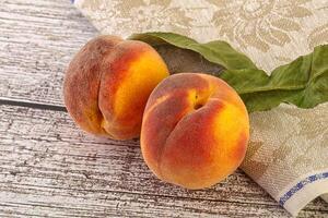 Two ripe sweet peaches fruit photo