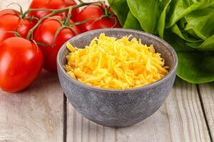 Shredded cheese in the bowl photo