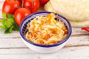 Fermented cabbage sauerkraut in the bowl photo