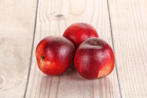 Ripe sweet juicy nectarines heap photo