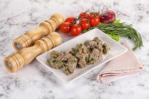 Fried turkey liver with herbs in cream sauce photo