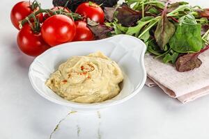 Creamy hummus in the bowl photo