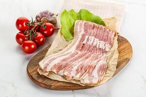 Sliced pork bacon oved board photo