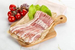 Sliced pork bacon oved board photo