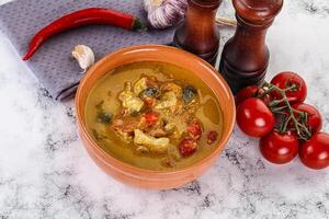 Traditional yellow Thai curry with chicken photo